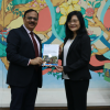 Dr. Prasun K Das APRACA Secretary General handing over a report on global landscape of green finance to Ms. Maria Theresa Medialdia Mekong Institute Director.